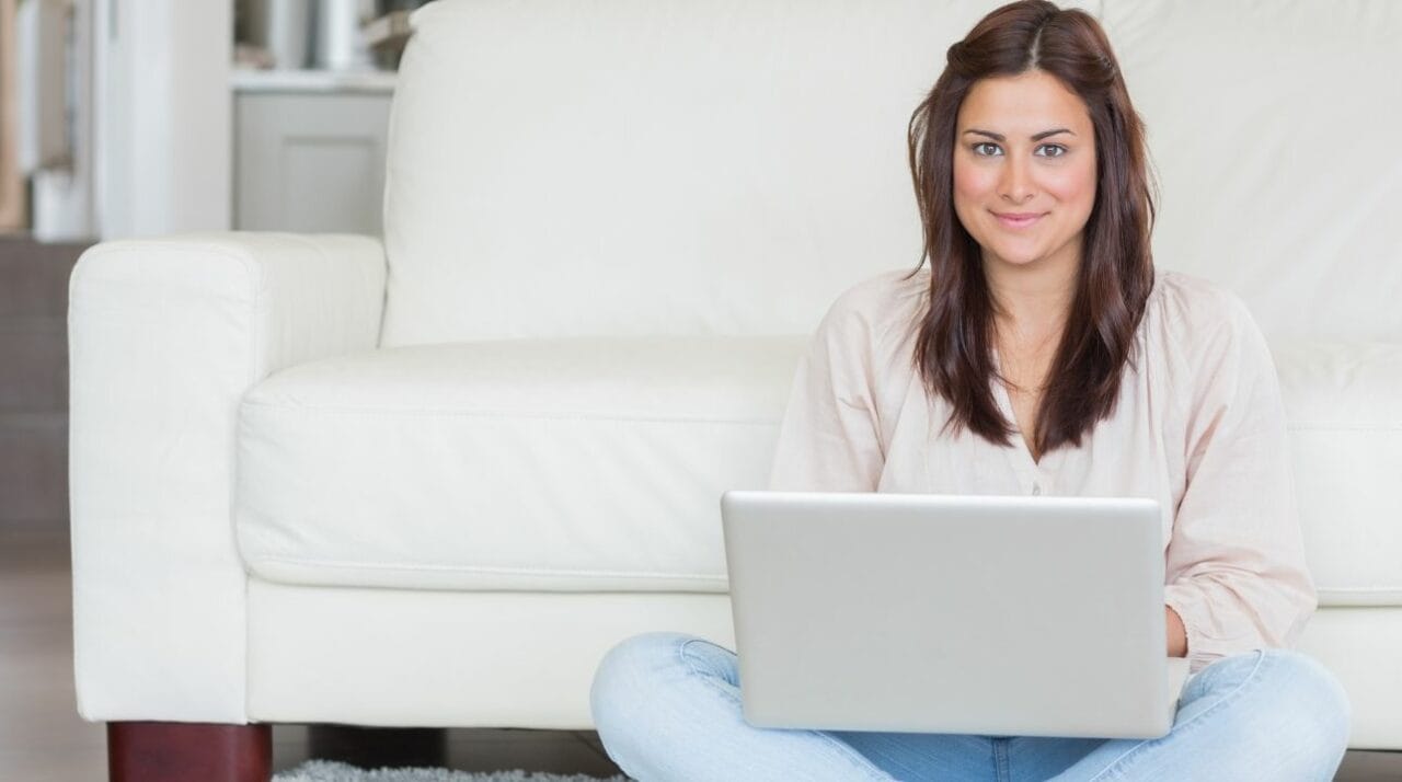 A young woman working on her laptop and learning more about the right email address format
