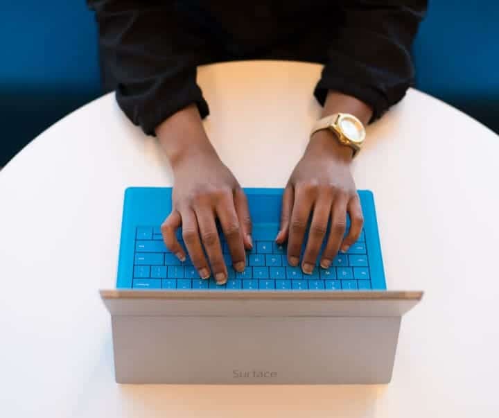 person typing on a keyboard looking at email verification techniques. 