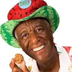 Picture of Wally Amos with the cookie kahuna bag in his hand for an ad. 